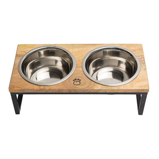 Handcrafted mango wood and metal elevated pet feeder with two stainless bowls on a matte black frame.